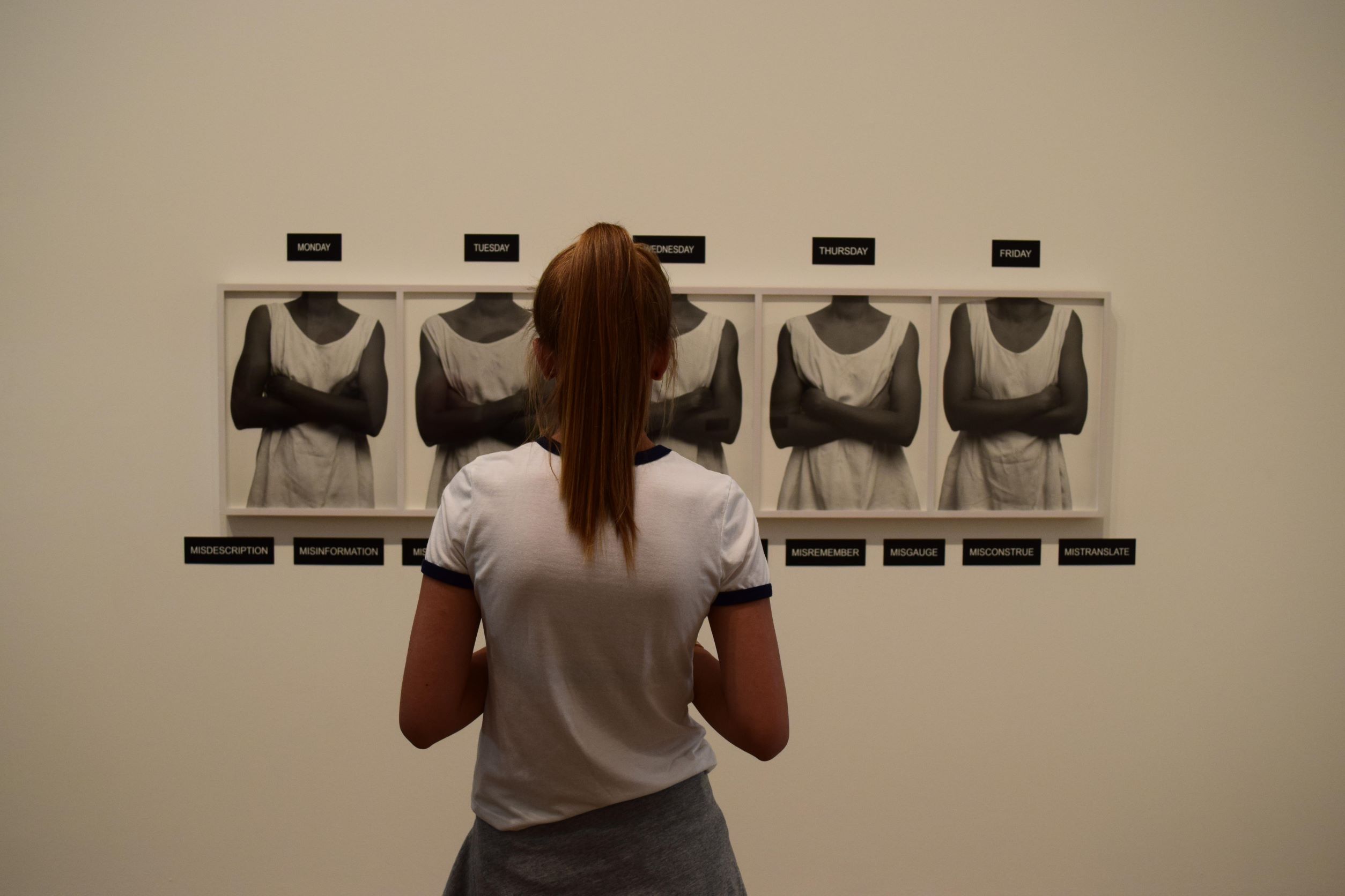 Young woman in white t-shirt looking at Five Day Forecast by Lorna Simpson at Tate Britain. Andrew Innes / Alamy Stock Photo