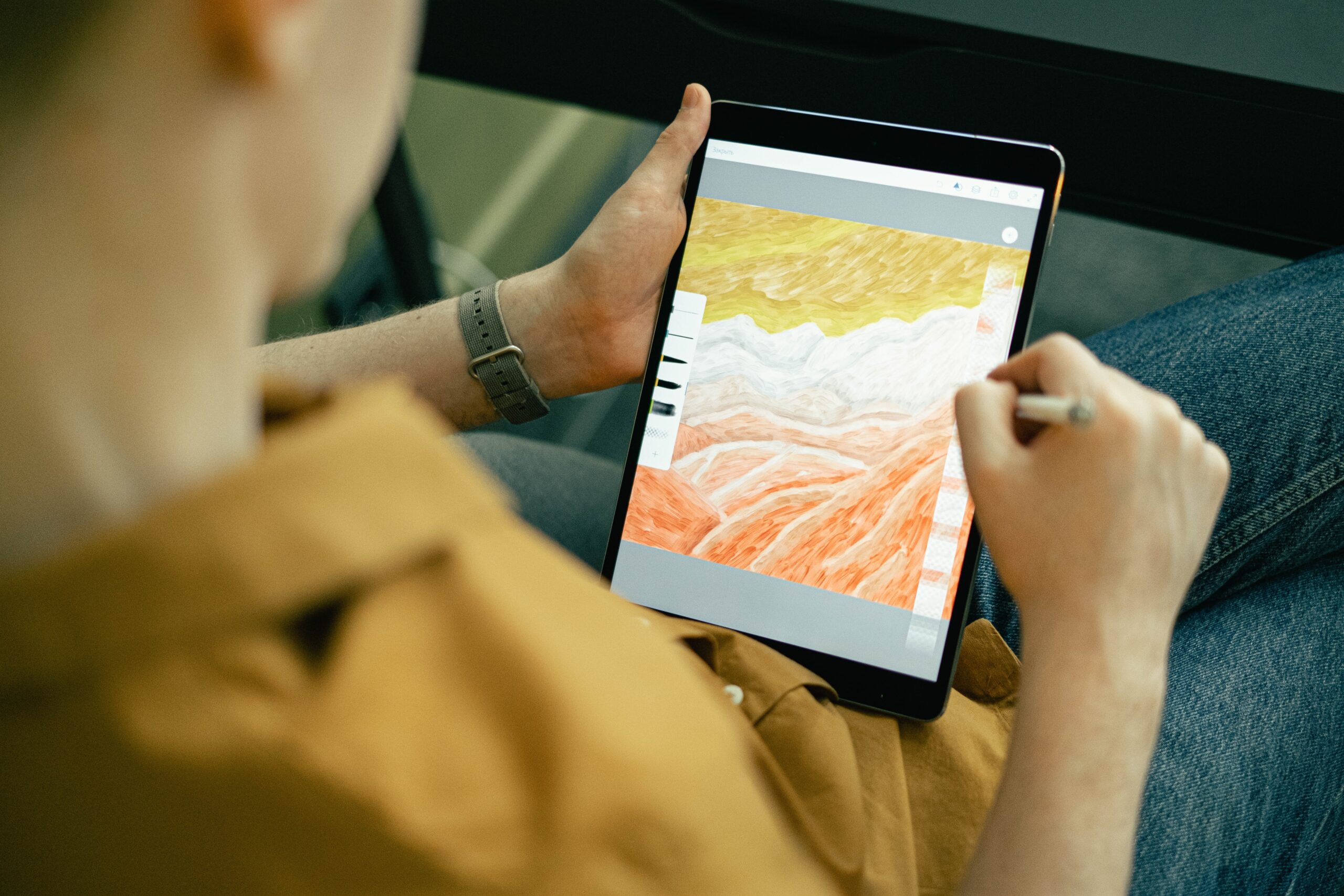 Digital artist using tablet. Photo by Ivan Samkov on Pexels