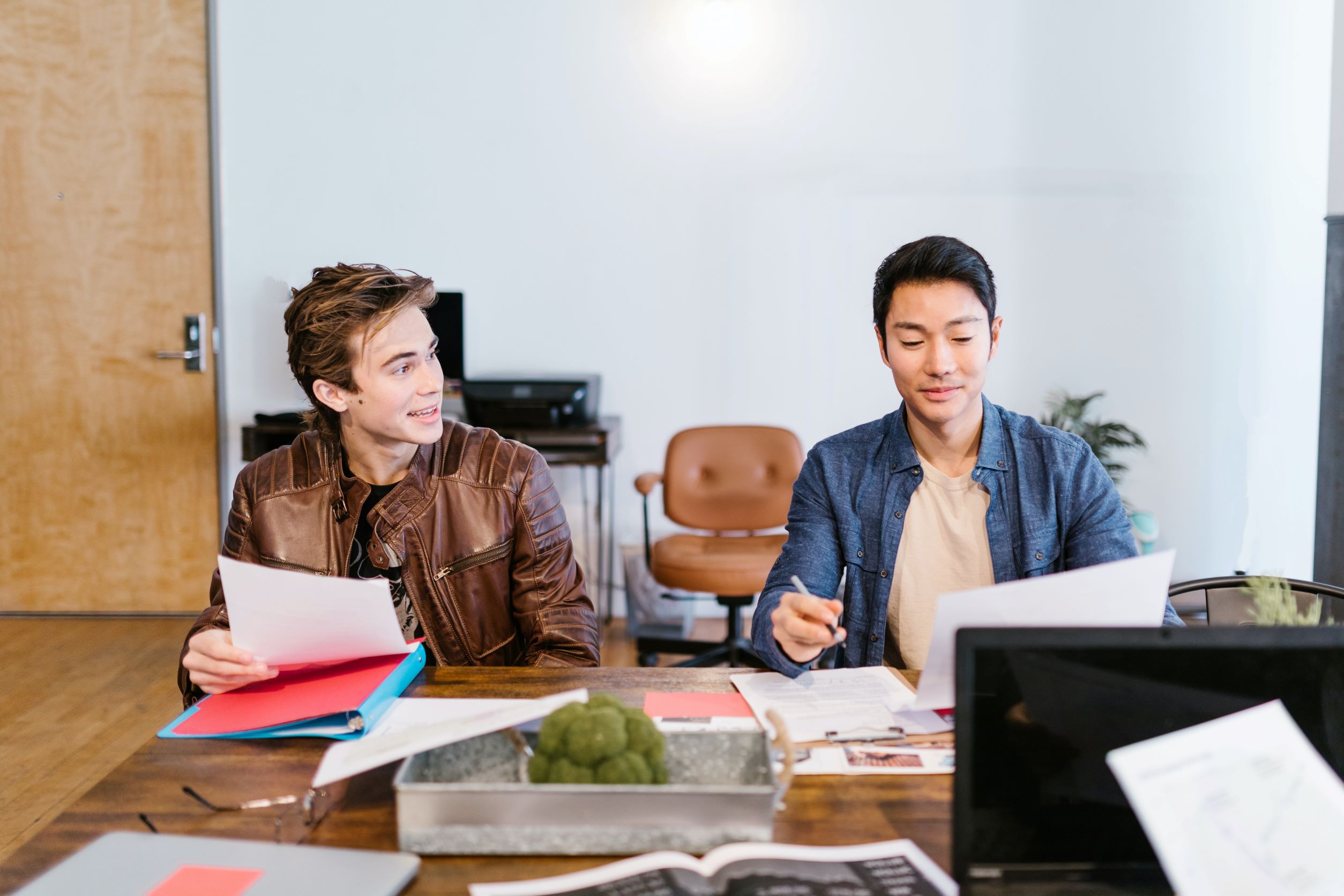 Two men sit at a meeting for crowdfunding investments. Photo by Rodnae on Pexels