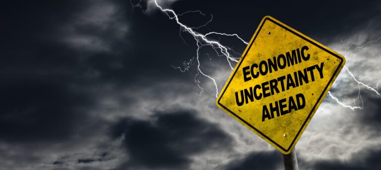 Economic Uncertainty Ahead Sign With Stormy Background