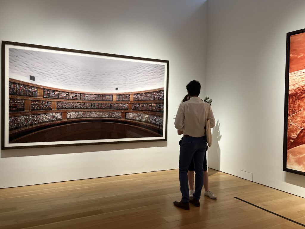 Couple in front of Andreas Gursky's Bibliothek at the Paul Allen Collection preview. Photo by Micaela Preble 