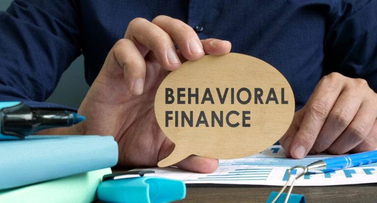 Man holds plate with behavioral finance words.